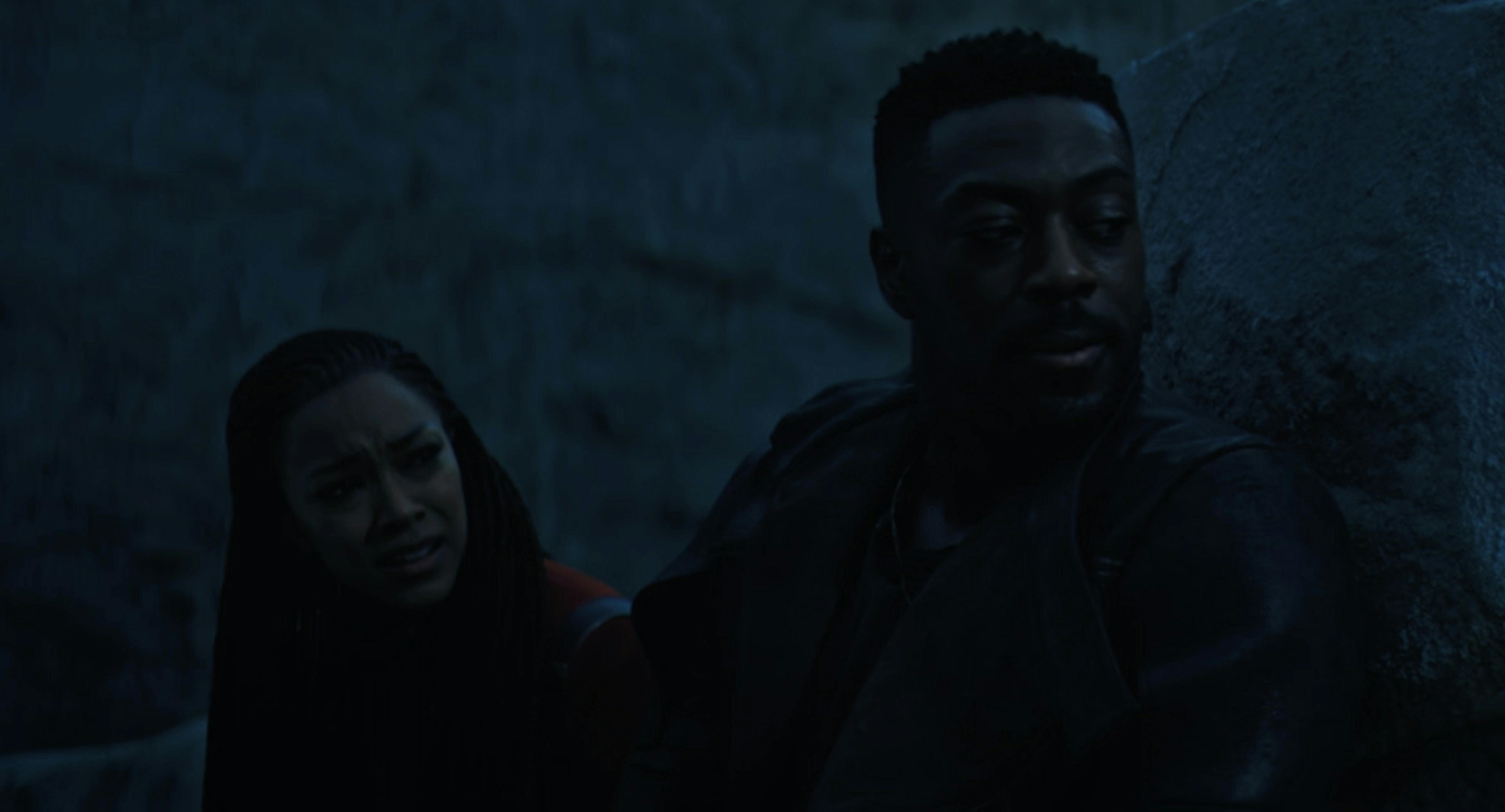 Michael Burnham and Cleveland Booker take cover behind a boulder from an attacking creature in an exclusive CCXP 2023 clip of Star Trek: Discovery Season 5