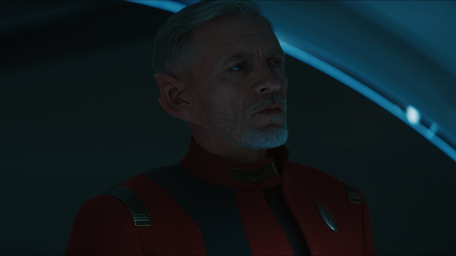 Rayner pensively stares at his window at Starfleet Headquarters in 'Under the Twin Moons'