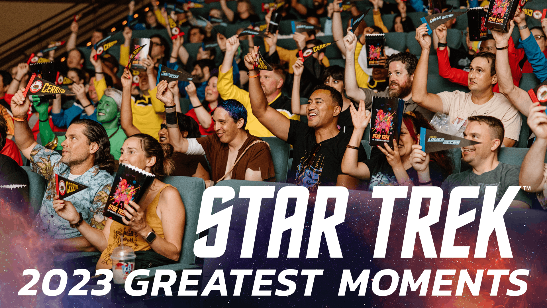 A theater full of Star Trek Lower Decks fans holding Cerritos pennants and flashing the Vulcan salute with an overlay of text stating 'Star Trek 2023 Greatest Moments'